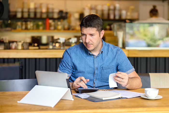 An entrepreneur calculating the cost of starting a new business.